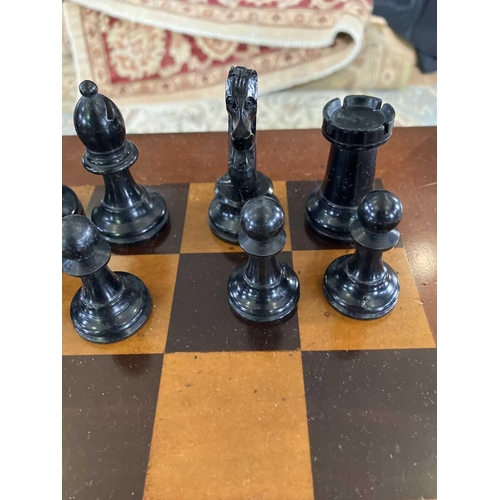 37 - A Staunton pattern ebonised and boxwood chess set, and a small chess table. The unweighted set in or... 