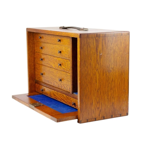 62 - An oak stationary cabinet, early-mid 20th century. The interior with five drawers, height 32cm, widt... 