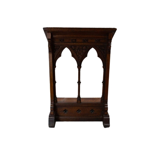 65 - A Victorian Gothic oak lectern. Carved with flowers and foliage, and with turned column pilasters. H... 