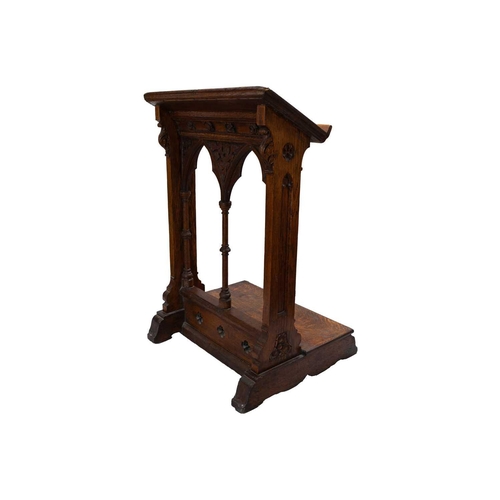 65 - A Victorian Gothic oak lectern. Carved with flowers and foliage, and with turned column pilasters. H... 