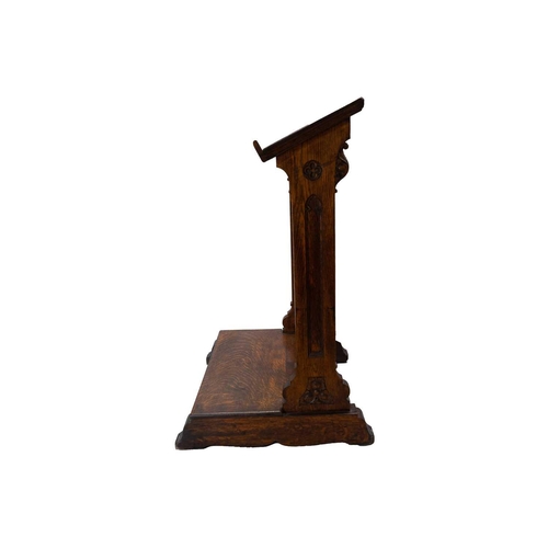 65 - A Victorian Gothic oak lectern. Carved with flowers and foliage, and with turned column pilasters. H... 