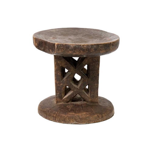 95 - A Zimbabwean Tonga stool. Mid 20th century, with a dished circular top and trellis carved support, h... 