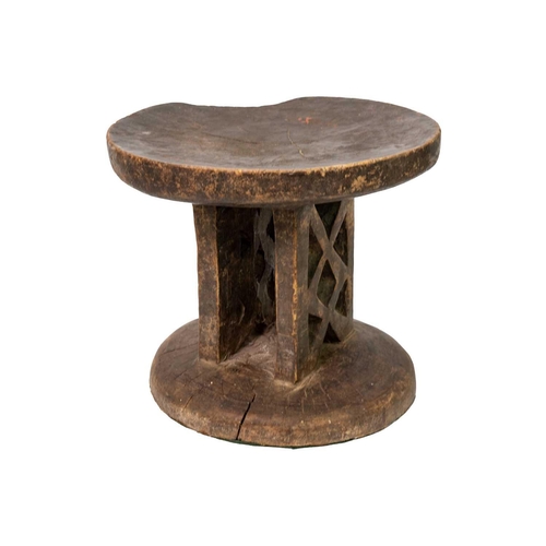 95 - A Zimbabwean Tonga stool. Mid 20th century, with a dished circular top and trellis carved support, h... 