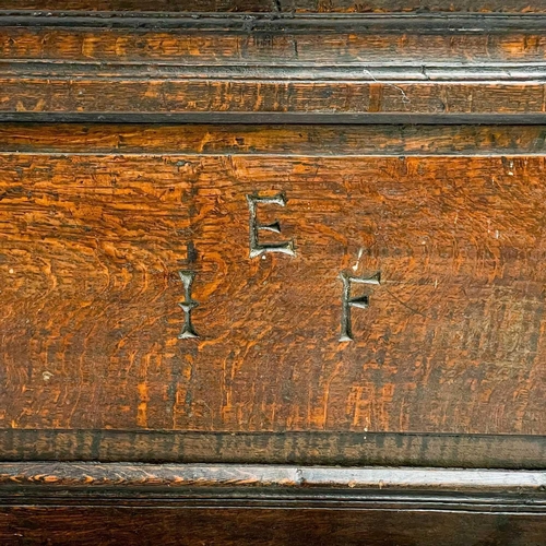 1056 - A late 17th century oak coffer. The two panel front initialled EIF and dated 1696, height 62cm, widt... 