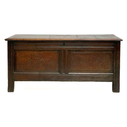 1056 - A late 17th century oak coffer. The two panel front initialled EIF and dated 1696, height 62cm, widt... 