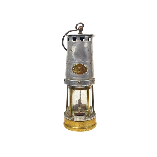 105 - A miner's lamp, labelled 3. Serial number 48136, height 26cm, together with a copper ships binnacle ... 