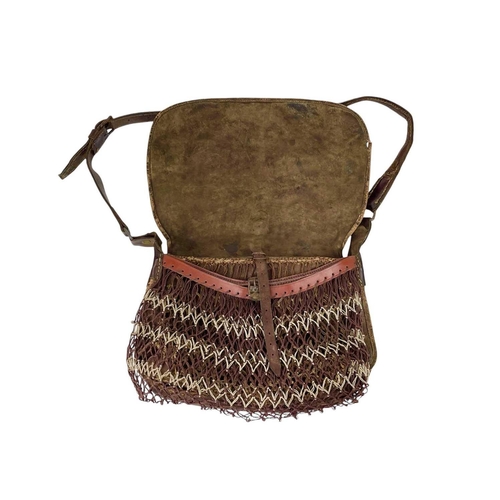 11 - A leather poacher's or hunter's bag. Circa 1920, with cartridge compartments and a net bag, with str... 