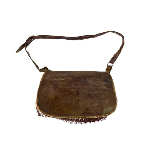 11 - A leather poacher's or hunter's bag. Circa 1920, with cartridge compartments and a net bag, with str... 