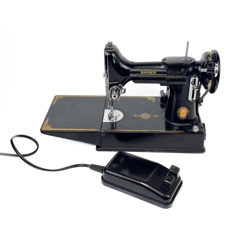 116 - A Singer Electric Sewing Machine No.221K. Serial No. EG 349320 1951 date with black case and accesso... 