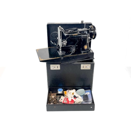 116 - A Singer Electric Sewing Machine No.221K. Serial No. EG 349320 1951 date with black case and accesso... 