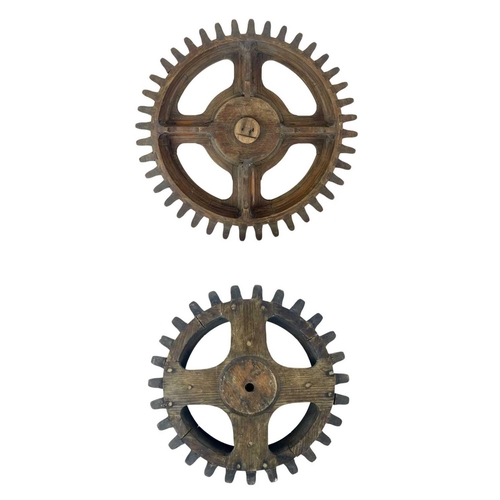 130 - Two hardwood cog patterns One stamped number 404, and the other 7, the larger 38.5cm diameter (2).