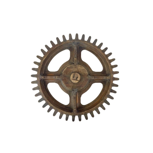 130 - Two hardwood cog patterns One stamped number 404, and the other 7, the larger 38.5cm diameter (2).