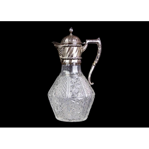 154 - A Victorian silver mounted cut glass claret jug. Of bellied form with star, lozenge and hobnail cut ... 