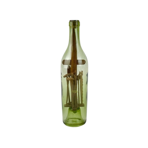 159 - A folk art 'God in a Bottle' The green glass bottle circa 1900, containing a pitch pine cross with a... 