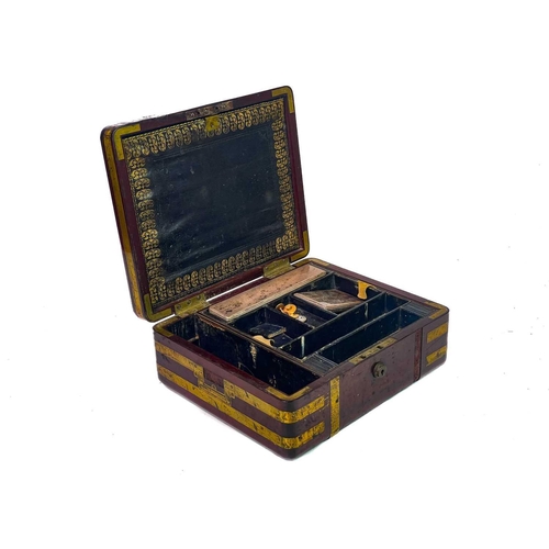 183 - A good William IV mahogany and brass bound campaign dressing case. The inside lid with a descriptive... 