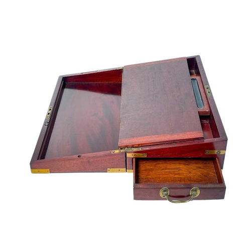 21 - A George IV mahogany and brass bound campaign writing box. With a fitted interior and side drawer, h... 