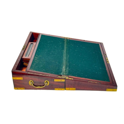 21 - A George IV mahogany and brass bound campaign writing box. With a fitted interior and side drawer, h... 