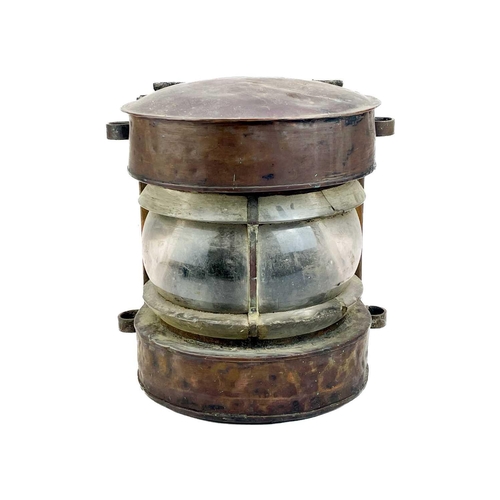 237 - A ship's copper mast lantern. With a clear glass lens, height 35 cm.