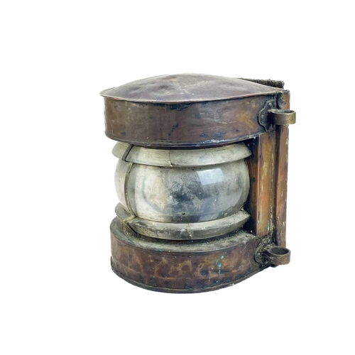 237 - A ship's copper mast lantern. With a clear glass lens, height 35 cm.