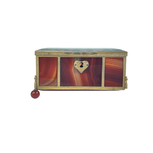 31 - A polished moss and banded agate trinket box. 19th century, with engine turned gilt metal mounts, on... 