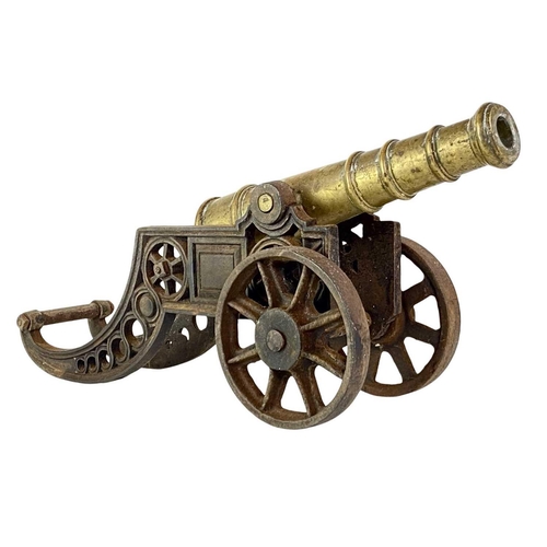 4 - A brass and iron model cannon. Height 21cm length 46cm.