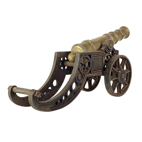 4 - A brass and iron model cannon. Height 21cm length 46cm.