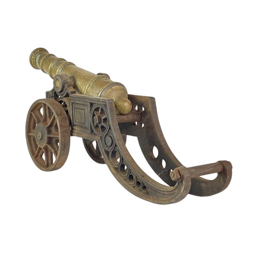 4 - A brass and iron model cannon. Height 21cm length 46cm.