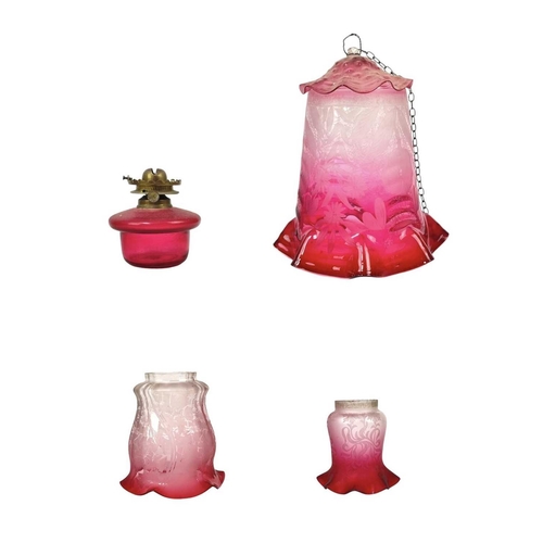 53 - A cranberry glass lampshade, and two others. Circa 1900, with a scalloped rim, the gradient colour w... 