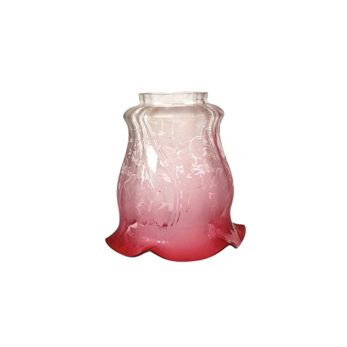 53 - A cranberry glass lampshade, and two others. Circa 1900, with a scalloped rim, the gradient colour w... 