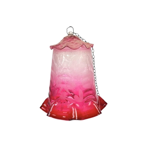 53 - A cranberry glass lampshade, and two others. Circa 1900, with a scalloped rim, the gradient colour w... 