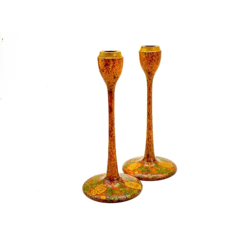 81 - A pair of Arts and Crafts style poker work candlesticks. With slender columns and rose decorated cir... 