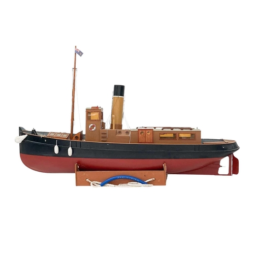 91 - A well made kit built radio controlled model of a steam tug boat. With stand, height 70cm length 115... 