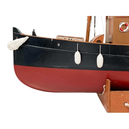 91 - A well made kit built radio controlled model of a steam tug boat. With stand, height 70cm length 115... 