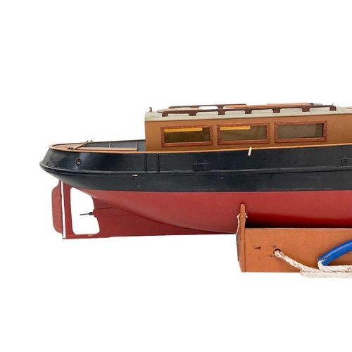 91 - A well made kit built radio controlled model of a steam tug boat. With stand, height 70cm length 115... 