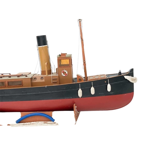 91 - A well made kit built radio controlled model of a steam tug boat. With stand, height 70cm length 115... 