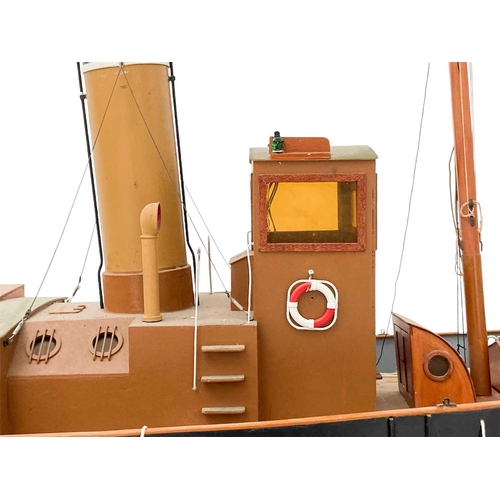 91 - A well made kit built radio controlled model of a steam tug boat. With stand, height 70cm length 115... 