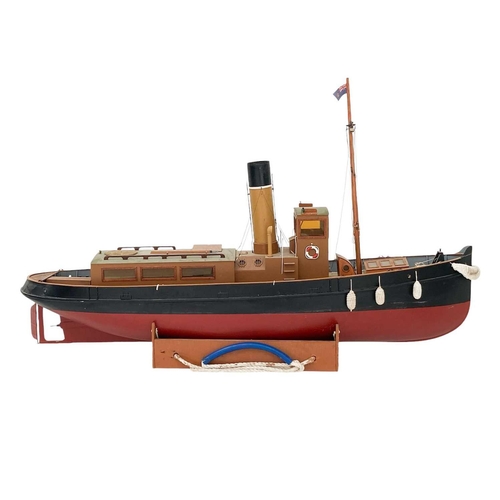 91 - A well made kit built radio controlled model of a steam tug boat. With stand, height 70cm length 115... 