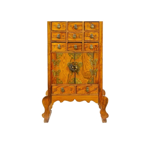 1 - A Chinese hardwood brass bound medicine cabinet, 20th century. With an arrangement of twenty drawers... 