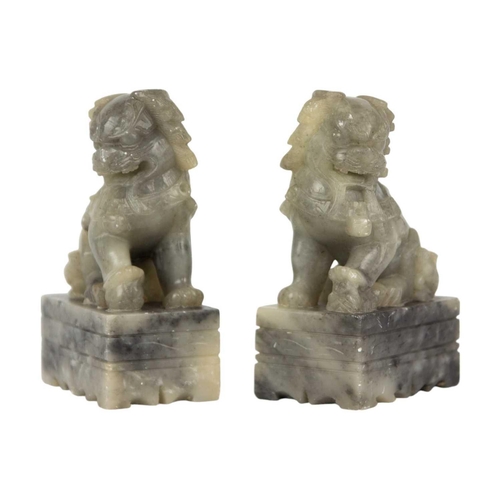 114 - A pair of Chinese soapstone dogs of fo, 20th century. Height 13cm, width 8.5cm, depth 5cm. (2)