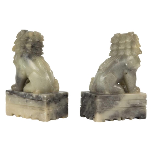 114 - A pair of Chinese soapstone dogs of fo, 20th century. Height 13cm, width 8.5cm, depth 5cm. (2)