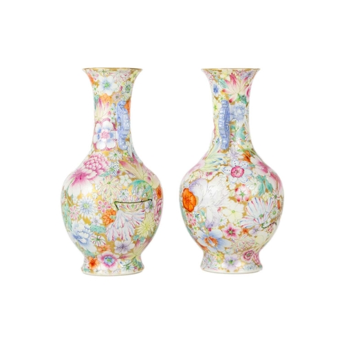 135 - A pair of Chinese millefleur twin handled vases, circa 1900. Profusely decorated with enamelled flow... 