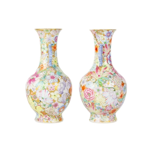 135 - A pair of Chinese millefleur twin handled vases, circa 1900. Profusely decorated with enamelled flow... 