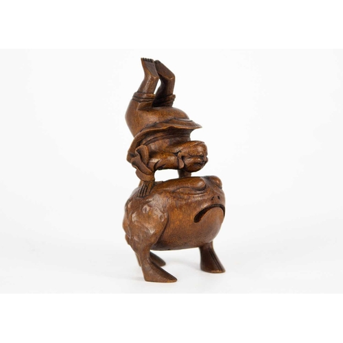 142 - A Chinese carved bamboo figure, late 19th/early 20th century. Depictung an acrobat on a large toad, ... 