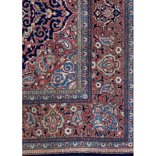 152 - A Kashan rug, Central Persia, circa 1920. The dark indigo field with a polychrome floral medallion, ... 