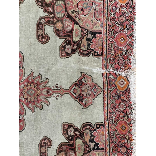 153 - A Malayer rug, West Persia, circa 1900. With a central lobed polychrome medallion, within a madder m... 