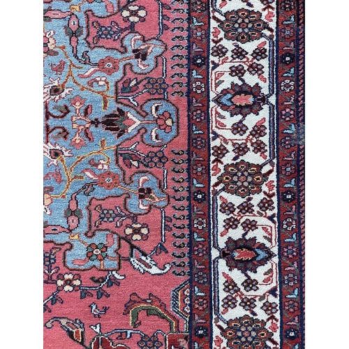 154 - A fine Hamadan rug, North West Persia, circa 1930's. The madder field with a pale blue and pink cent... 