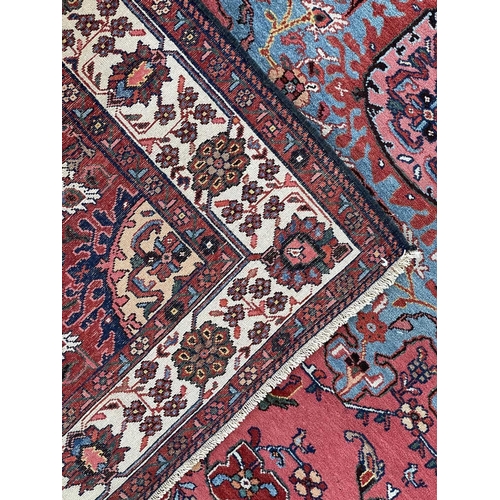 154 - A fine Hamadan rug, North West Persia, circa 1930's. The madder field with a pale blue and pink cent... 