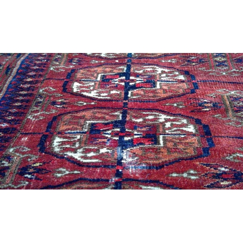 155 - A Tekke Turkoman rug, circa 1930. The madder field with twenty-one rows of three octagonal medallion... 