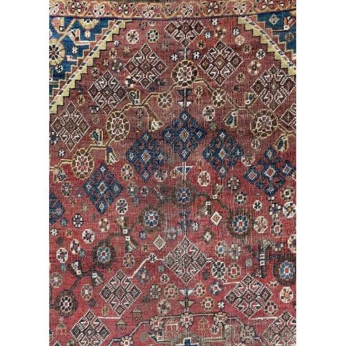 167 - A Ghashgai rug, South West Persia, circa 1920. The madder field with a central indigo medallion, hoo... 