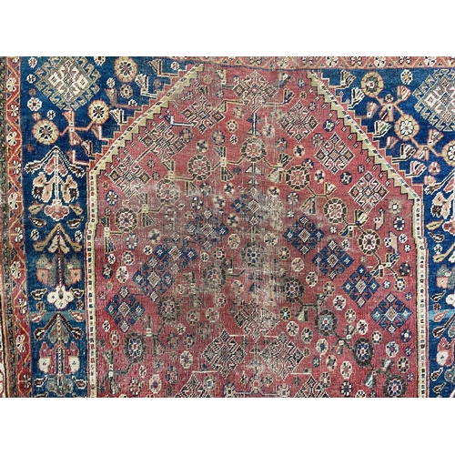 167 - A Ghashgai rug, South West Persia, circa 1920. The madder field with a central indigo medallion, hoo... 